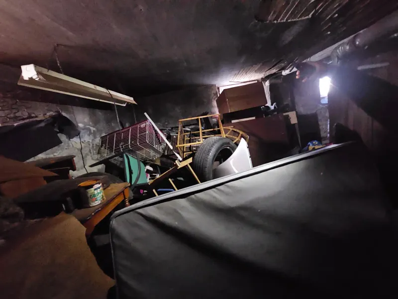 Cluttered basement full of stored items before cleanout service near Barnstable