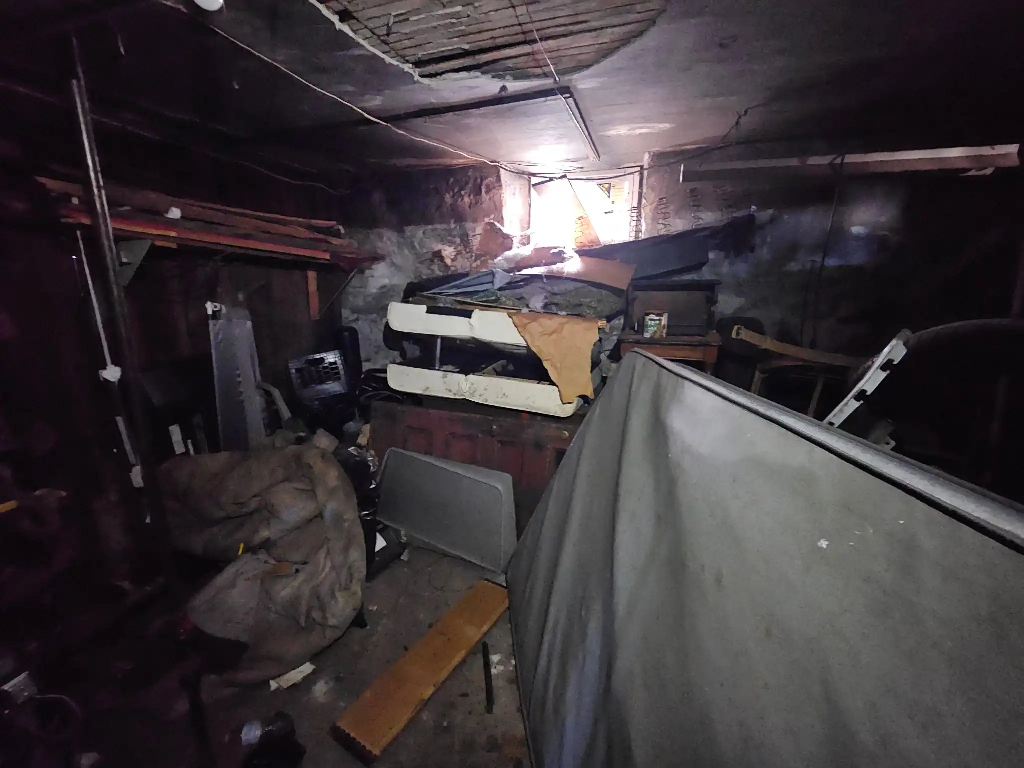 Basement before cleaning out old furniture and boxes in South Coast