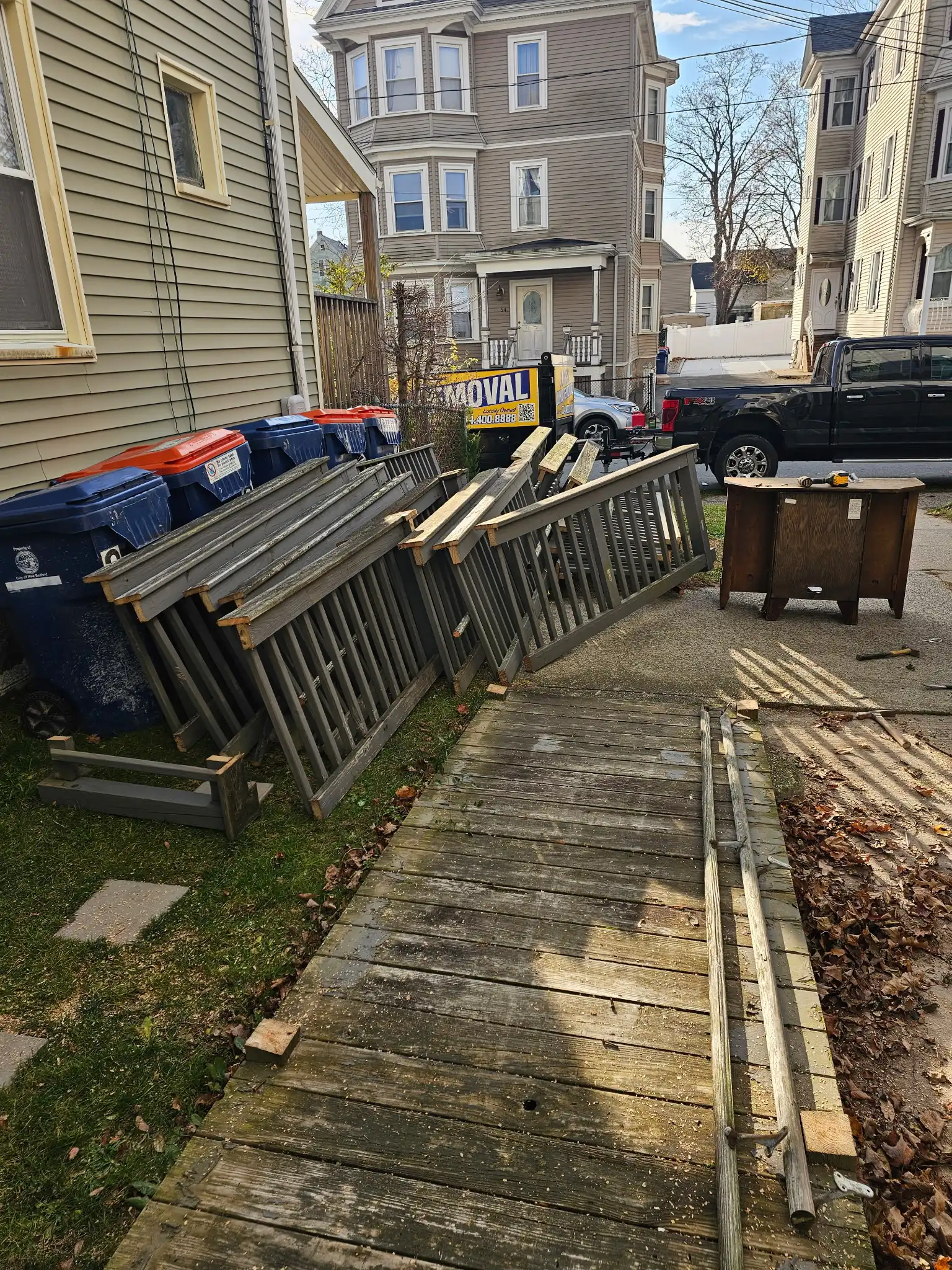 Old railings and ramp materials being removed from a South Coast home